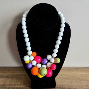 Vintage 1960s plastic necklace with cluster of multicolored round beads.